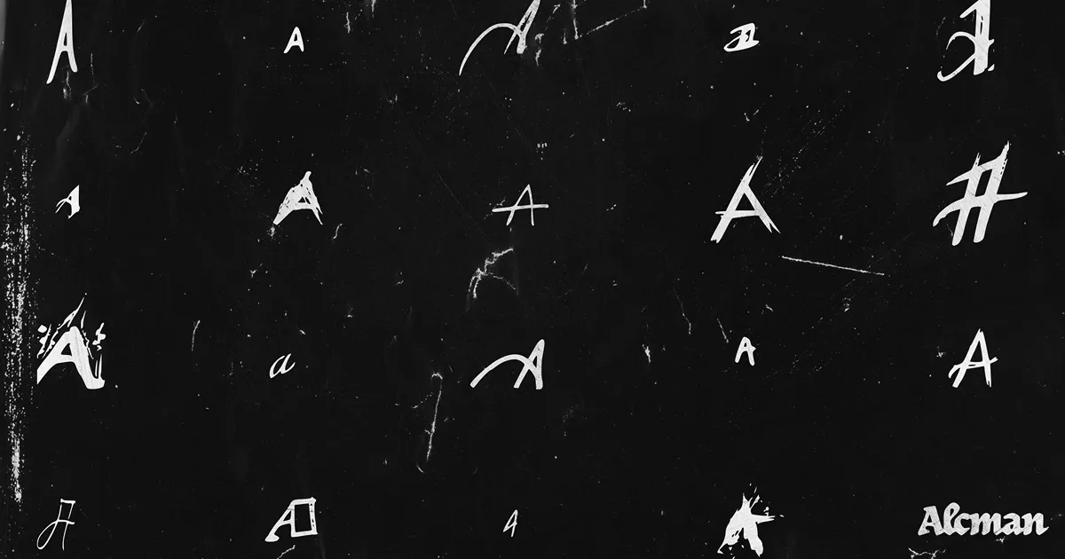 The handwritten variations of the letter A created for the logo laid on a black paper-like background